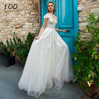 I OD Modern A-vonalú esküvői ruha Mély V-nyakú rátétekkel Sapkaujjak Illúzió gomb Padló hosszúságú menyasszonyi ruha Vestidos De Novia